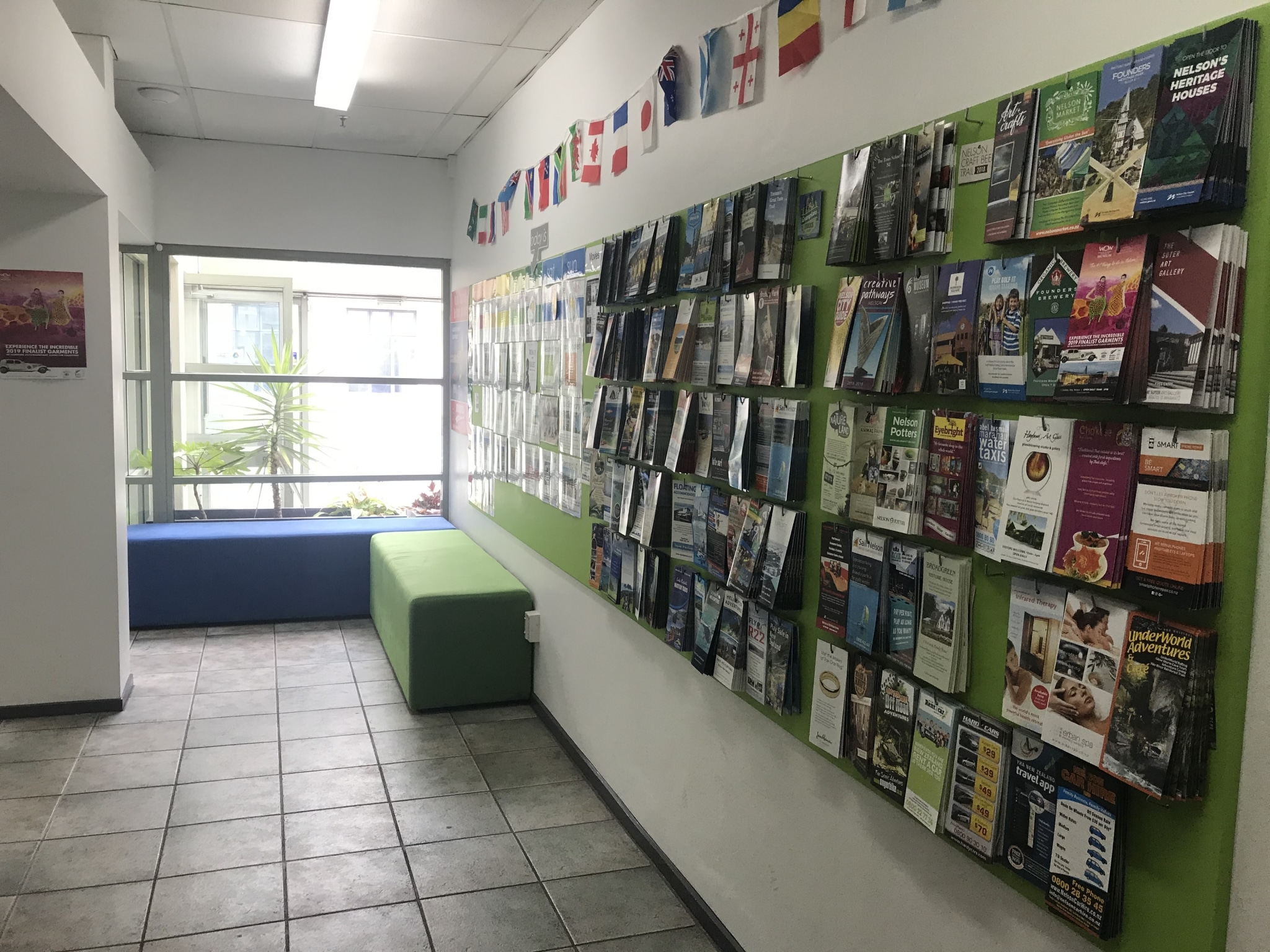 Hostel Reception with Brochure information wall with lots of local activity providers including Abel Tasman tours and things to do in Nelson