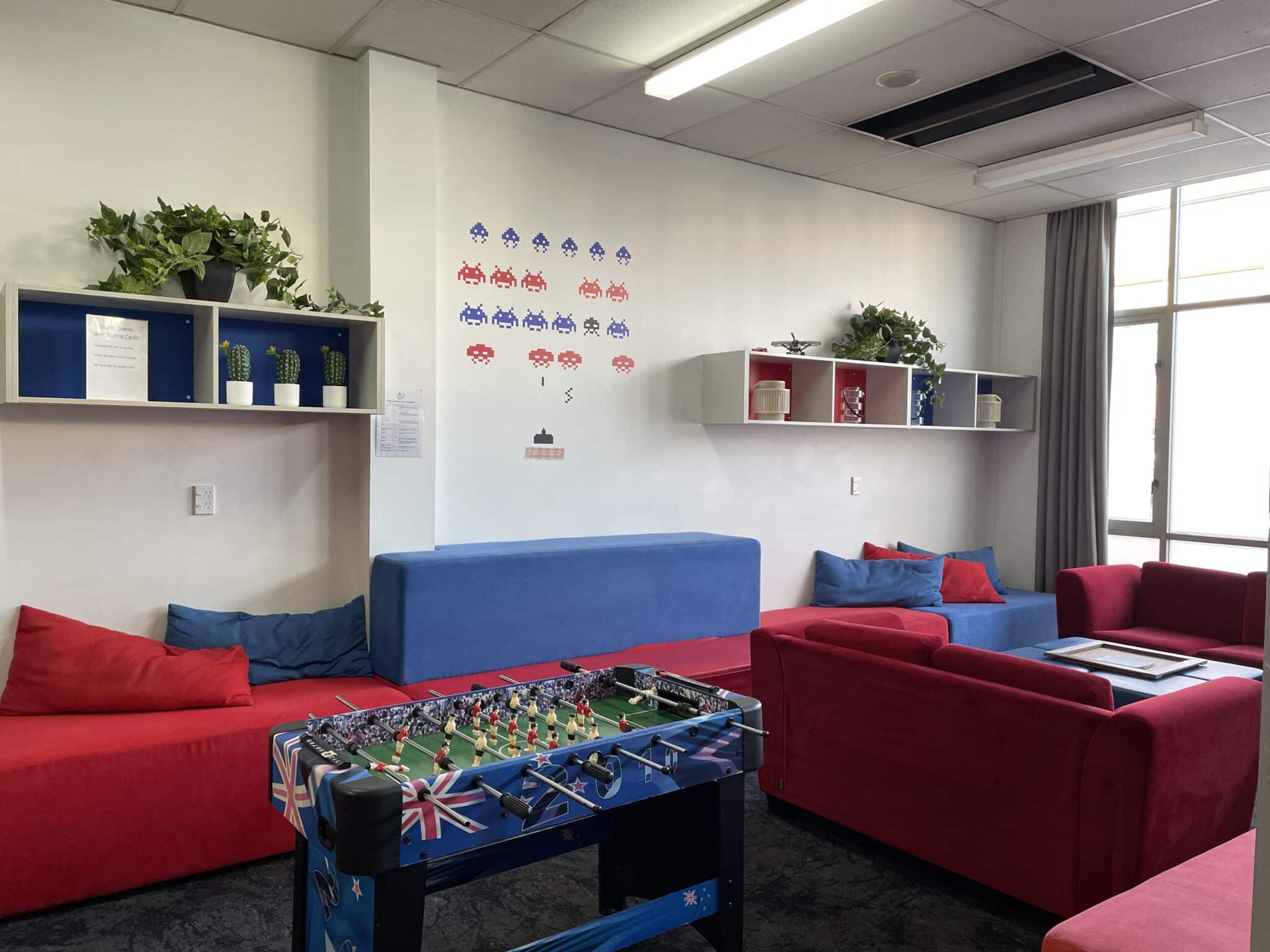 Spacious lounge with modular sofas, bean-bags, work-stations, a foosball table and board games