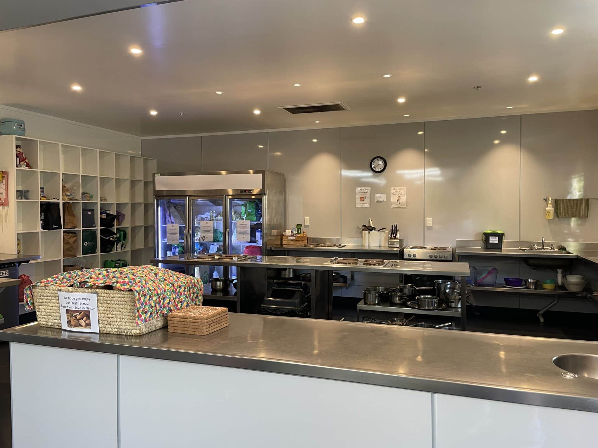 Spacious, well-equipped hostel kitchen at Accents YHA Hostel Nelson, featuring modern appliances and ample counter space